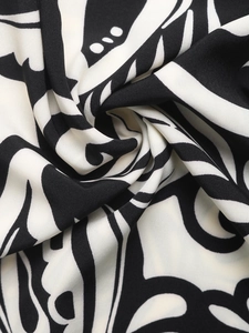 Close-up of high-quality fabric with black and white abstract swirl floral print patterns