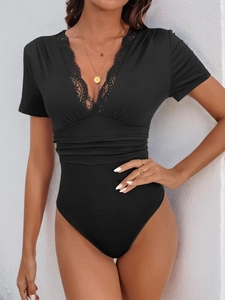Detail of V-neck bodysuit with delicate lace trim and slimming pleated waist texture