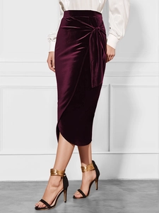 Detail view showing textured burgundy velvet wrap skirt and side tie knot detail
