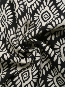 Detailed macro view of ethnic geometric print on high-quality black and white woven fabric