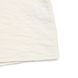 Close-up of white bow shirt fabric with natural crinkle texture and neat stitching