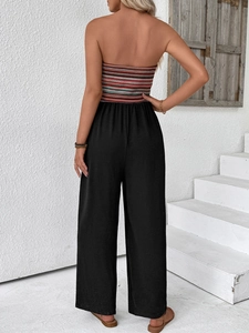 Detailed back view of a summer striped tube top jumpsuit with wide leg black trousers