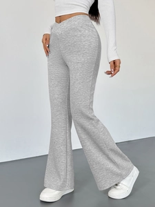 Women's slim fit grey flared yoga pants featuring a V-shaped cross waist and split hem