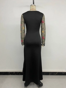 Detailed back view of a slim fit black dress with mesh sleeves and floral embroidery
