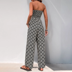 Bohemian geometric print strapless jumpsuit with smocked bodice and wide leg cut