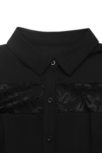 Detail shot of black dress featuring a classic collar and elegant lace patchwork design