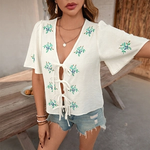 Women's white cotton embroidered top with bow ties and floral bell sleeves