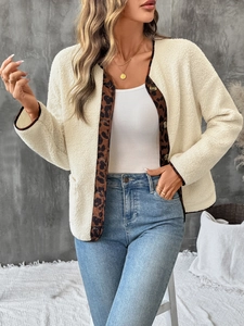 Close-up of leopard print patchwork collar and amber buttons on white fleece jacket