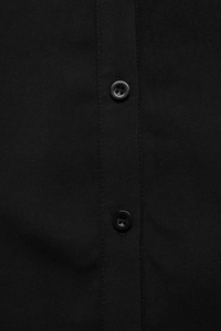 Close-up of black lace patchwork dress with high-quality four-hole buttons and fine texture