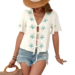 White V-neck embroidered top with tie-front bow design and bohemian floral patterns