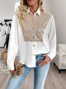 Detailed shot of white shirt featuring gold sequin panel and metallic button accents