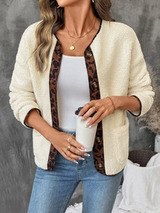 Detail of plush fleece jacket featuring leopard print lining and contrast trim buttons