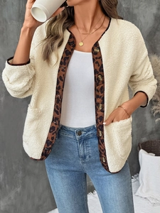 Close-up of beige sherpa cardigan with leopard print trim and gold metal buttons