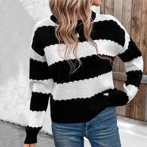 Close-up of high-quality knit texture and bold black and white stripes on a crewneck sweater
