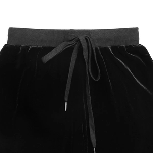 Close-up of elastic waistband with black velvet drawstring and metal tips on trousers
