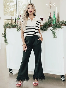 Detail of a zip-up striped knit vest with a polo collar and side slits for women