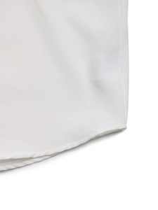 Detail view showing neat hemline stitching and smooth white fabric on a sequined shirt