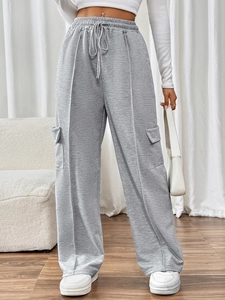 Detailed view of high-waisted grey cargo trousers with elastic drawstring and front seams