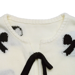 Gilet en tricot blanc à motifs noirs et fermeture à nœud pour le style d'automne
