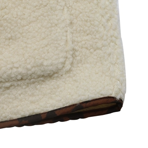 Detailed macro view of plush cream fleece fabric with leopard print trim detailing