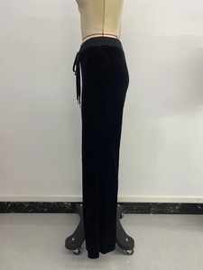 Detailed close-up of high-waist velvet wide leg trousers with adjustable drawstring waist
