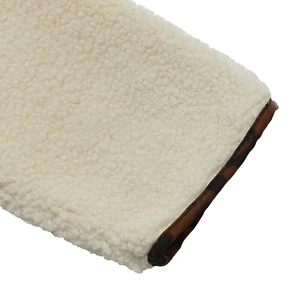Detail of cream sherpa fleece texture and leopard print contrast piping on the jacket