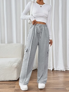 Detail of high waist drawstring grey wide leg trousers with large utility side pockets