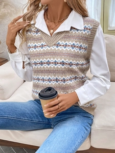 Detail of V-neck knitted vest with geometric jacquard pattern layered over a white shirt