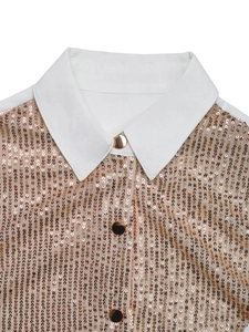 Detail of white collar and golden sequins on the long sleeve fashionable blouse