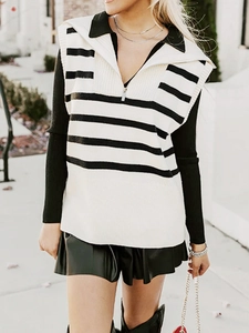 Detail of zip-up striped knit vest with turn-down collar and thick ribbed texture