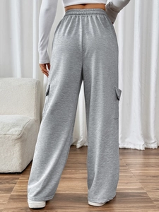 Detail of grey high-waisted wide-leg joggers with elastic waistband and side cargo pockets