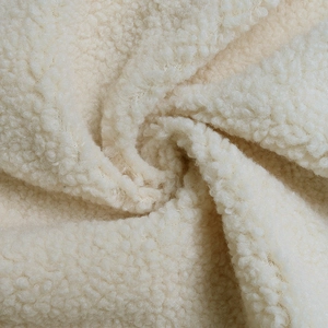 Close-up of soft leopard print plush texture on creamy sherpa fleece cardigan fabric