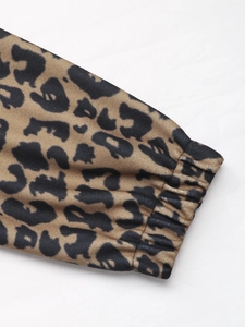Detail of leopard print jacket showing elastic cuffs and high-quality fabric texture