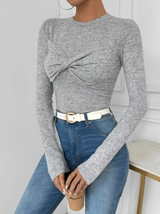 Detail of grey twist-front knit top featuring soft texture and stylish knot design