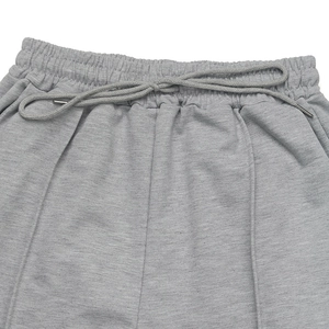 Detail of high elastic waist on grey sweatpants with drawstring and metal aglets