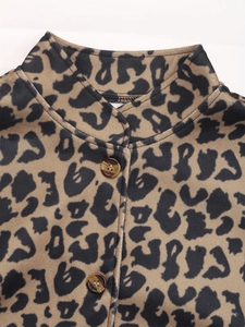 Detailed view of leopard print jacket with stand-up collar and marble texture buttons