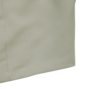Close-up of the light beige twill fabric texture and stitching of the blazer