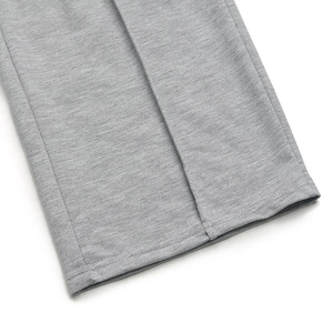 Detail of grey knitted fabric with reinforced double stitching on the trouser hem
