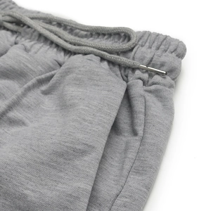 Detail of elastic high waist joggers with woven drawstring and metallic tips