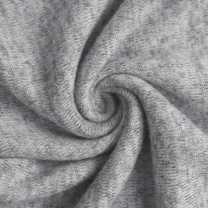 Macro shot of light gray knitted fabric texture with soft ribbed pattern and delicate weave