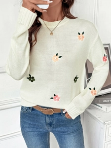 Detailed view of floral embroidery on a soft cream knitted round neck sweater for women