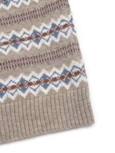 Detailed macro view of Nordic geometric jacquard pattern and ribbed hem on knitted vest