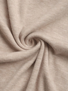 Close-up of beige knitted fabric with fine ribbed texture and soft marled finish