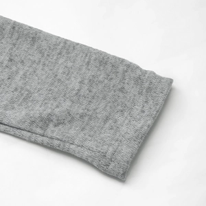 Detailed macro view of the grey knit fabric texture and high-quality hem double stitching
