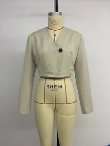 Close-up of a cropped khaki blazer with a deep V-neckline and single dark button closure