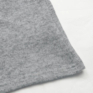 Close-up of marl grey knit fabric detail with clean stitched hem and fine texture