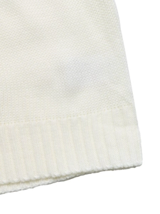 Close-up of white knit fabric texture featuring fine stitching and ribbed knit cuffs