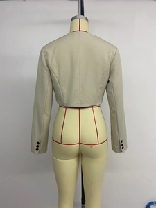 Detail view of beige cropped blazer back with three buttons on sleeve cuffs and slim fit cut