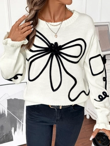 Détail du pull en maille blanc avec des broderies florales noires texturées en 3D