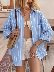 Detailed shot of striped long sleeve shirt with front pocket and white buttons detail